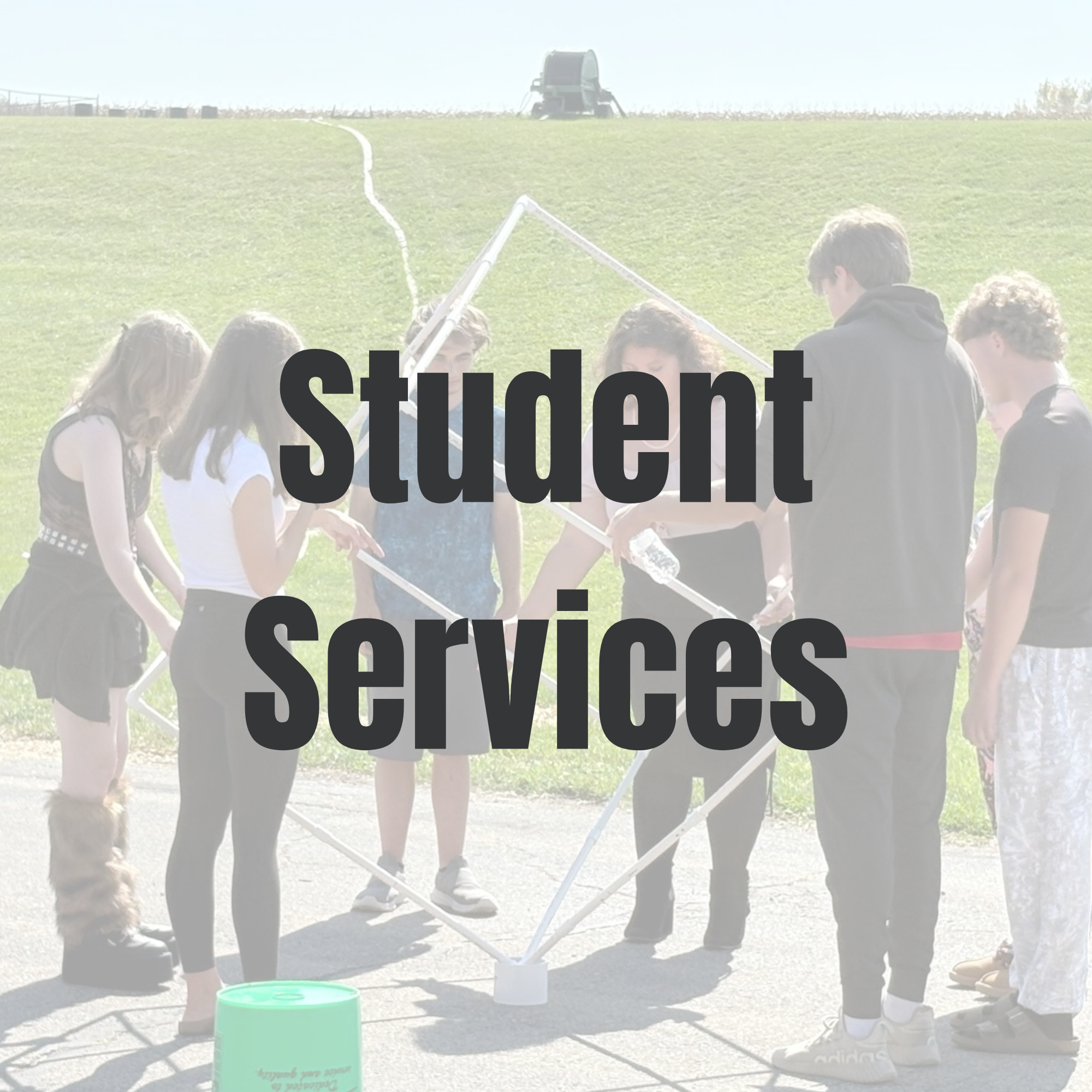 Button for the student services page, the words student services over students working on a project