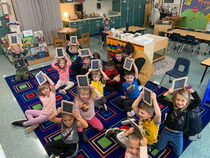 students writing on chalkboards